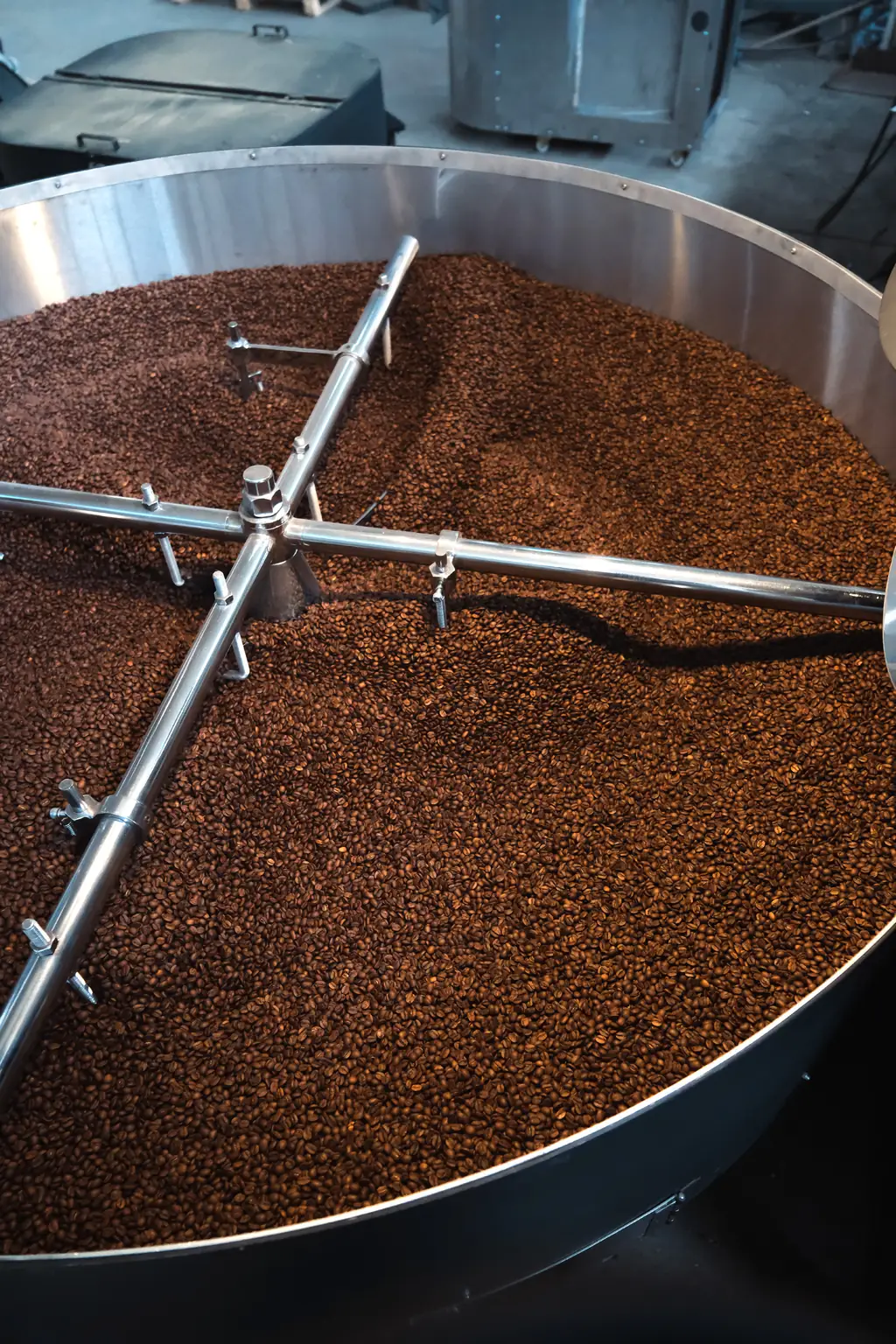 Freshly roasted coffee being mixed in the cooling tray